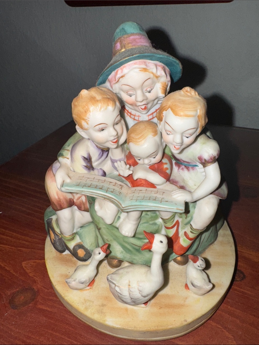 Vintage Shafford porcelain figurine Mother Goose reading to three children.